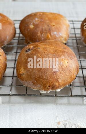 Freshly baked homemade sourdough fruit teacakes cooling on a rack. Stock Photo