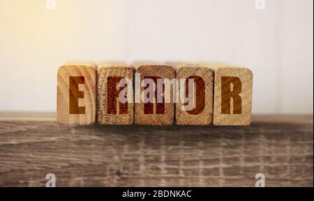 Macro Of The Word Error Formed By Wooden Blocks On A Wooden Table. Medical mistake concept. Mistakes in business startup concept Stock Photo