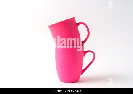 Stack with pink mugs isolated on white background, front view. Stock Photo