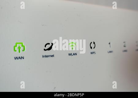 Extreme closeup shot of green lights of connection on internet modem Stock Photo