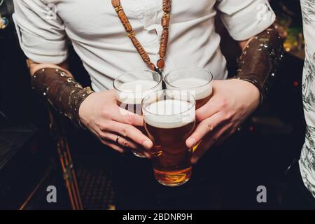 Cropped shot of a man holding glass of beer copyspace full glass of beer in the hand of a man at the bar recreation brewing tasty delicious cool refre Stock Photo