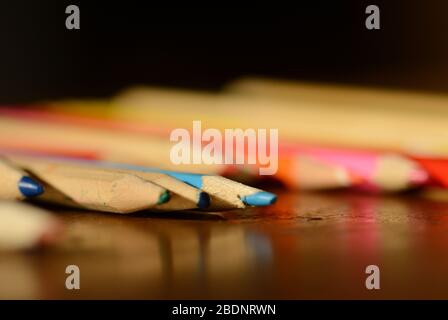 Used wooden color pencils on a table Stock Photo