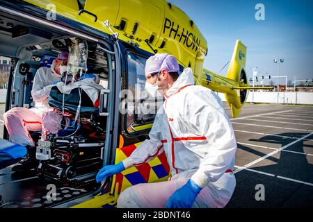 A medical worker getting on board the Lifeliner 5 ambulance helicopter as it prepares to depart for Germany carrying a COVID-19 coronavirus patient.Due to the large amount of patients infected with the COVID-19 coronavirus, the intensive care unit beds are in shortage in the Netherlands. Germany has agreed to help by accepting patients to receive treatments in hospitals in Germany. The Lifeliner 5 ambulance helicopter has been assigned to transport CCOVID-19 patients to German hospitals from the Netherlands. There are currently more than 20,000 confirmed cases of COVID-19 which has already cau Stock Photo