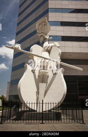 Vertical low angle view of the Giant Cellist, a David Adickes street sculpture in Theater District, Downtown Houston, Texas Stock Photo