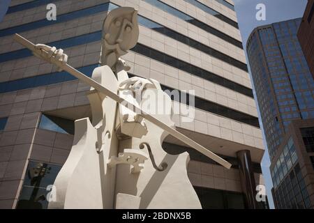 Horizontal low angle view of the Giant Cellist, a David Adickes street sculpture in Theater District, Downtown Houston, Texas Stock Photo