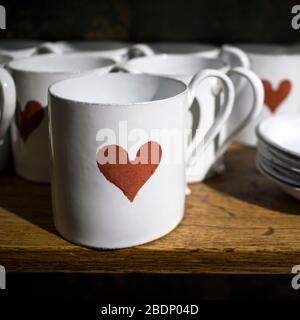 White porcelain mugs and saucers with a red heart print Stock Photo