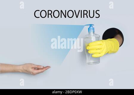 Woman holds out her hand for gel disinfection to protect against Coronavirus infection. COVID19. Text - Coronavirus. Stock Photo