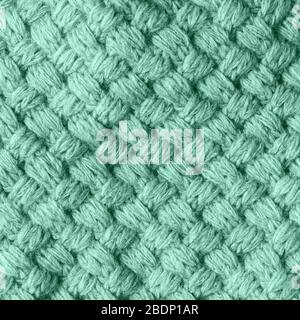 Flat lay Knitted homemade Woolen textured scarf in Neo mint color. Stock Photo