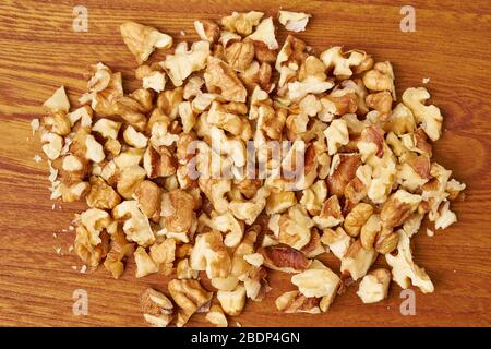 Chopped walnuts on wooden board. Step by step recipe for Banana bread. Stock Photo