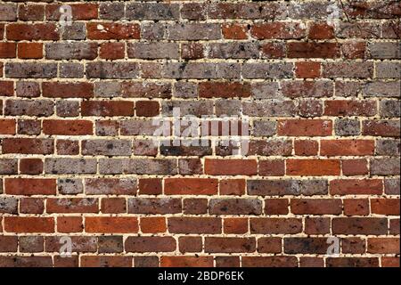 tfgacade of old brick wall with cracks and holes Stock Photo