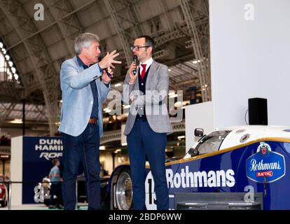 Tiff Needell describing his experiences of driving the Porsche 962C at Le Mans, with Motoring Expert  Max Girardo, on the Car Stories Stage at the 2020 London Classic Car Show Stock Photo
