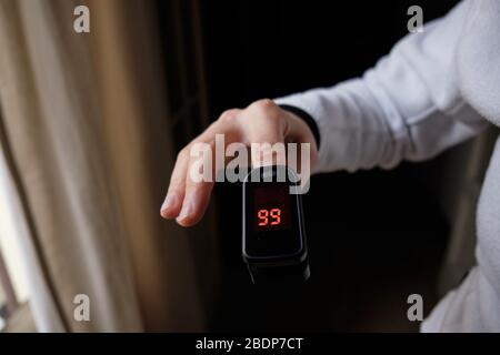 woman hand with Fingertip Pulse Oximeter Stock Photo