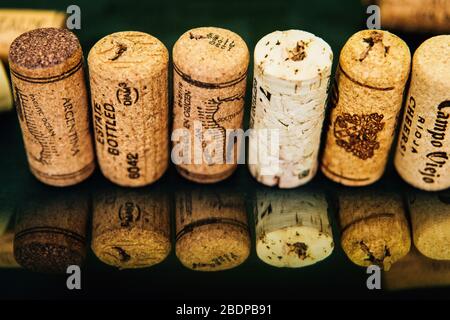 Corks lined up on a black background with reflection. Stock Photo