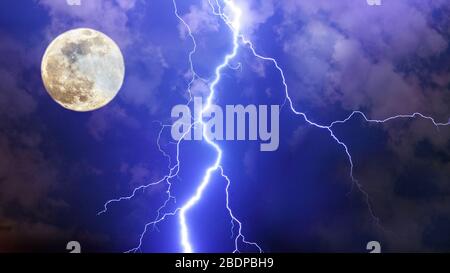 Dramatic thunderstorm night sky with big lightnings, clouds and full moon. Stock Photo