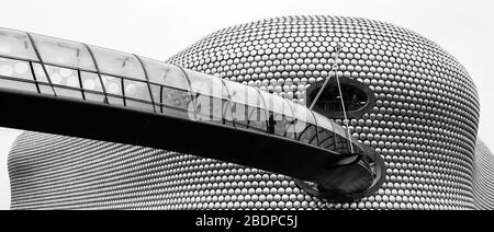 A man walks along the curved footbridge towards the iconic Selfridges Building in the heart of Birmingham city centre.  The building, which is part of Stock Photo