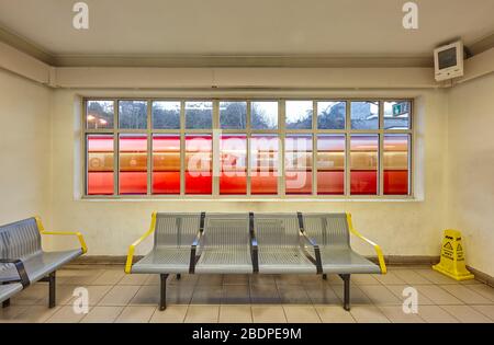 Waiting room interior at Finchley Central underground station with passing Tube train, London, UK. Stock Photo