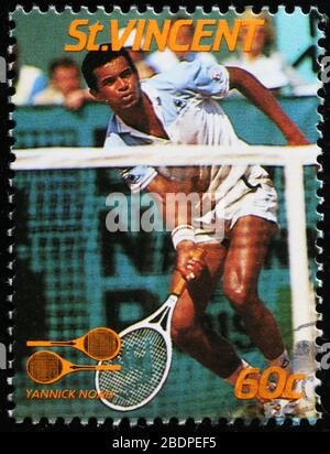Tennis champion Yannick Noah on postage stamp Stock Photo