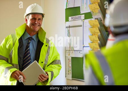 Portrait of a successful mature male architect holding a digital tablet at site Stock Photo