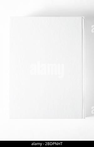 Mockup of closed blank square book at white textured paper background Stock Photo