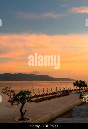 Vertical view across the Lombok Strait from Gili Trawangan to Lombok at sunset, Indonesia. Stock Photo