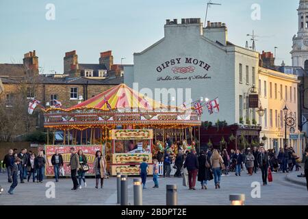 Funfair Carousel The Pride of London next to the Gipsy Moth Public House in Greenwich, London Stock Photo