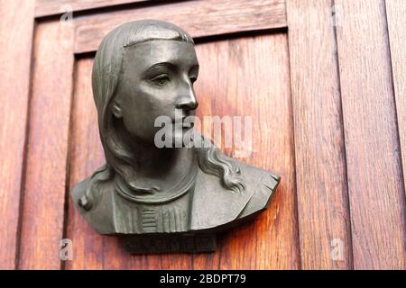 St Casimir head portrait, bust cast on the front wooden door of Saint Mary Basillica Church, Cracow, Main Market Square, Poland. Artist - Karol Hukan Stock Photo