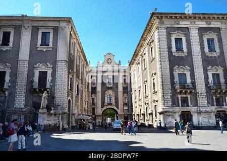 Ancient building with black walls and white columns and bricks and window frames in an Italian square on a sunny day Stock Photo