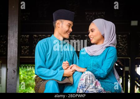 Portrait of happy Asian muslim couple smiling, husband and wife 