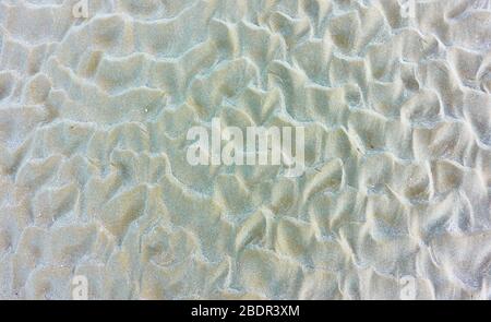 Natural texture of fine beach sand with waves -  textured background Stock Photo