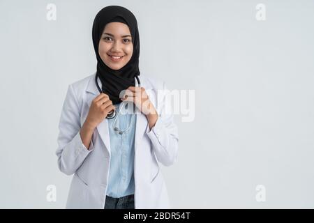 attractive muslim female doctor with white coat smiling Stock Photo