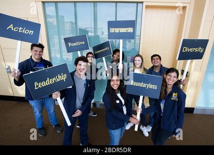 University of Michigan Ross School of Business students in Ann Arbor, Michigan holding inspirational signs during orientation day for new students. Stock Photo