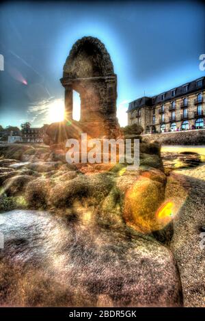 Village of Plouhmanac’h, France. Artistic silhouetted view of the Saint Guirec oratory on Ploumanac'h’s Plage Saint-Guirec. Stock Photo