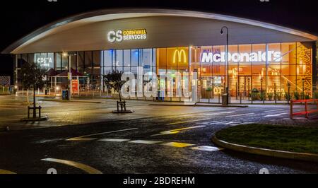 Victoria service on A30 in Cornwall, England. Night view on light full building and car park. Stock Photo