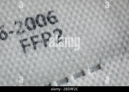 Macro and shallow depth of field image (selective focus) with the texture and inscriptions of a ffp2 anti covid-19 face and nose mask. Stock Photo
