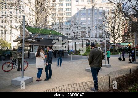 Diners at the Shake Shack in Madison Square Park in New York patiently practice social distancing as they wait for their take-out orders on Saturday, April 4, 2020. (© Richard B. Levine)