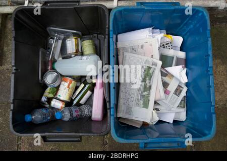 domestic recycling bins, blue for newspaper and cardboard, black for glass and plastics Stock Photo