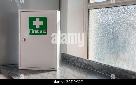 A First Aid Box with cross emblems on green background Stock Photo