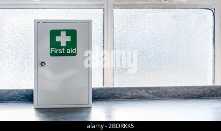 A First Aid Box with cross emblems on green background Stock Photo