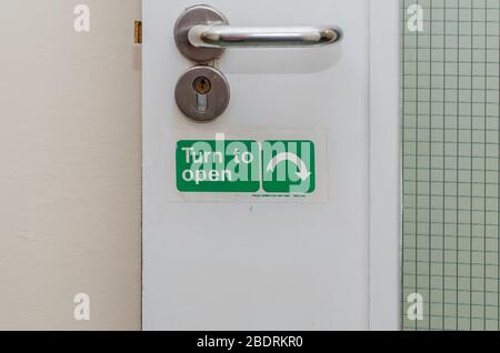 Turn to open turn arrow direction on a door Stock Photo