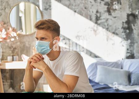 Serious male person being deep in thoughts Stock Photo