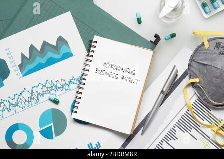 COVID-19 or Corona virus Business IMPACT background concept. Mockup Notebook for Covid 19 business impact anlysis with busines graphs sheets, N95 faci Stock Photo