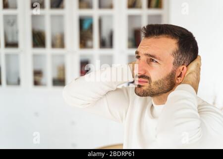 Upset young man staring into the distance Stock Photo