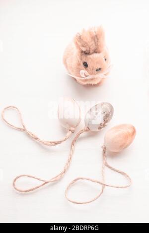 Cute creative photo with funny little rabbit and pastel color easter eggs on white background Stock Photo