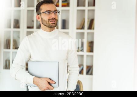 Handsome office worker standing in the workplace Stock Photo
