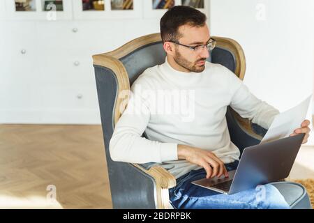 Man studying a document in his hand Stock Photo