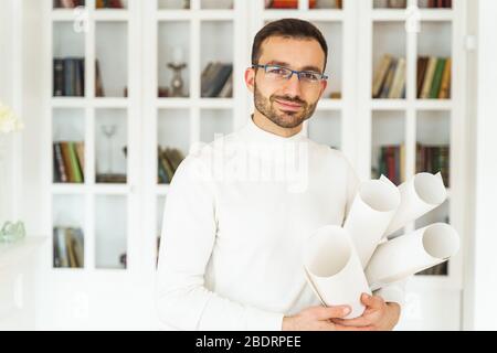 Smiling man in a white pullover looking forward Stock Photo