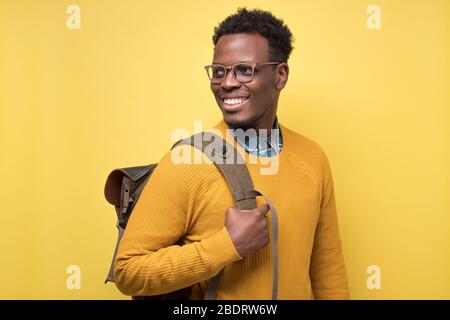 college student holding backpack and smiling being glad to study Stock Photo