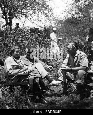 CLARK GABLE GRACE KELLY and Director JOHN FORD on set location candid in Africa during filming of MOGAMBO 1953 screenplay John Lee Mahin play Wilson Collison Metro Goldwyn Mayer Stock Photo