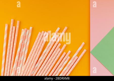 paper drinking straws on yellow,colorful background. Zero waste nature friendly biodegradable materials. Birthday party holiday celebration background Stock Photo