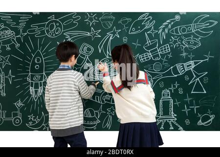 Happy children's study the universe cartoons on the blackboard Stock Photo